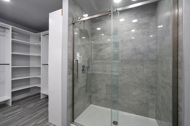 bathroom with wood-type flooring and walk in shower