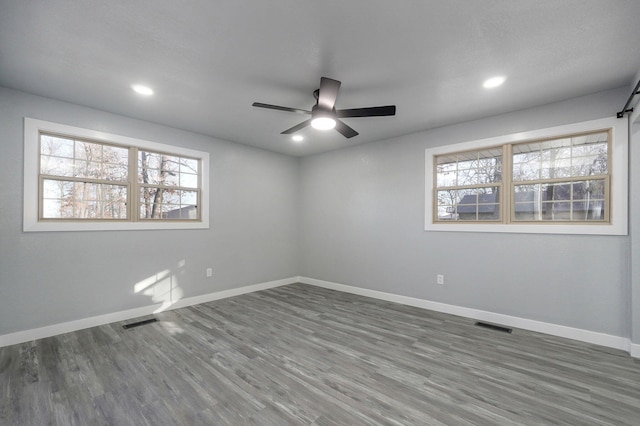 unfurnished room featuring dark wood-type flooring and ceiling fan