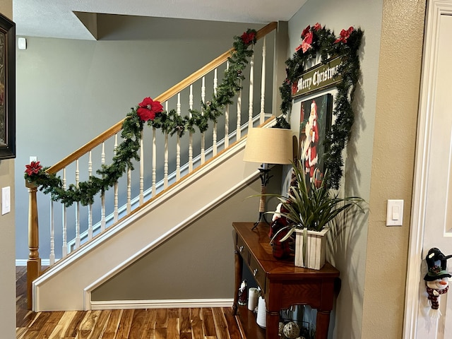 stairway featuring wood-type flooring