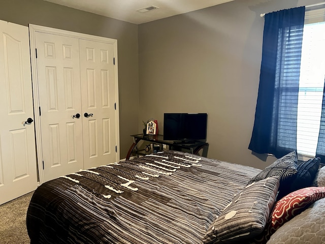 carpeted bedroom with a closet