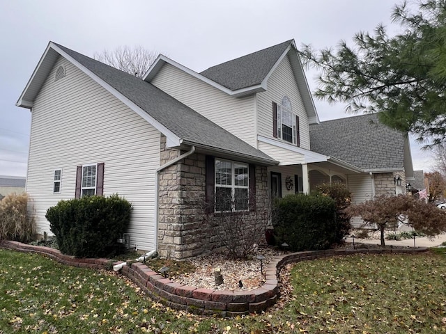 view of side of property with a yard