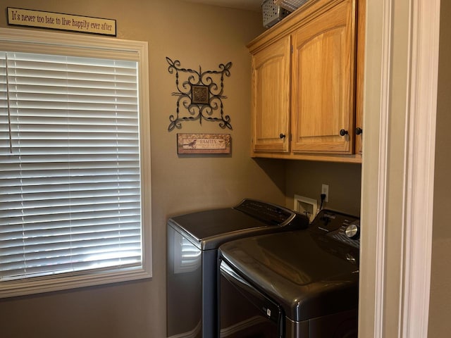 washroom with cabinets and washing machine and clothes dryer