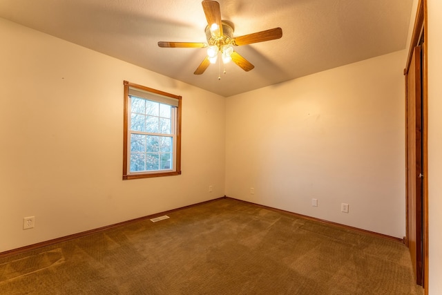 empty room featuring carpet and ceiling fan