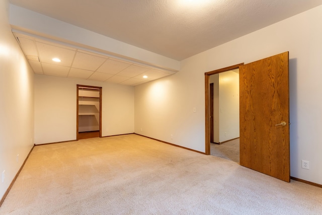 spare room featuring light colored carpet