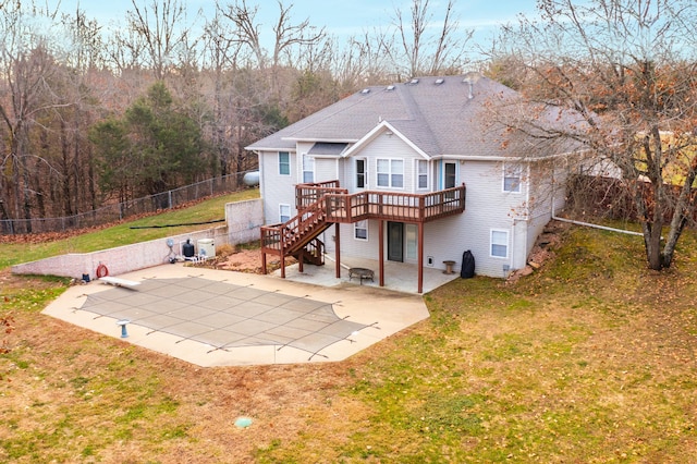 back of property with a patio area, a yard, and a deck