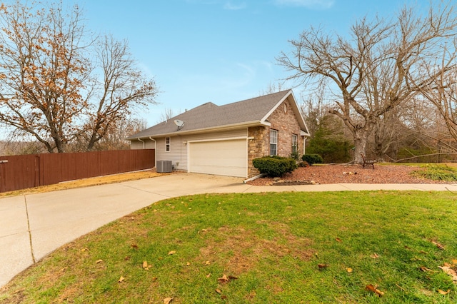 view of home's exterior featuring a garage, a lawn, and central air condition unit