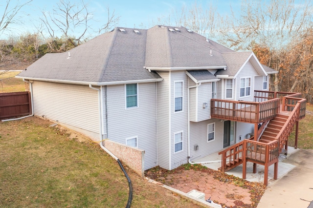 rear view of property with a lawn, a patio, and a deck