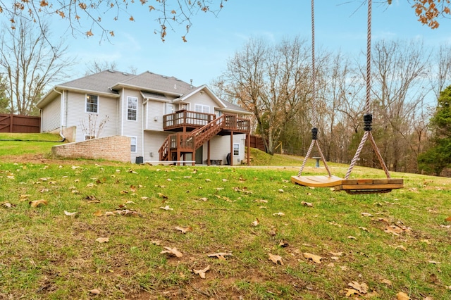 back of house featuring a lawn and a deck