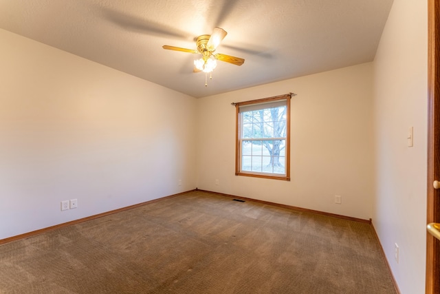 spare room with carpet flooring and ceiling fan