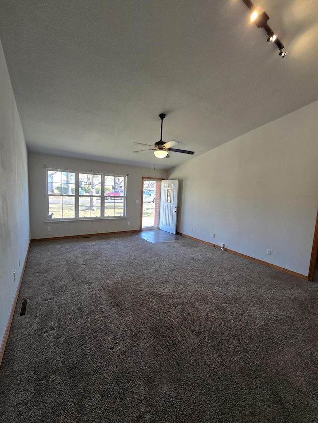 unfurnished living room featuring carpet flooring, ceiling fan, and track lighting