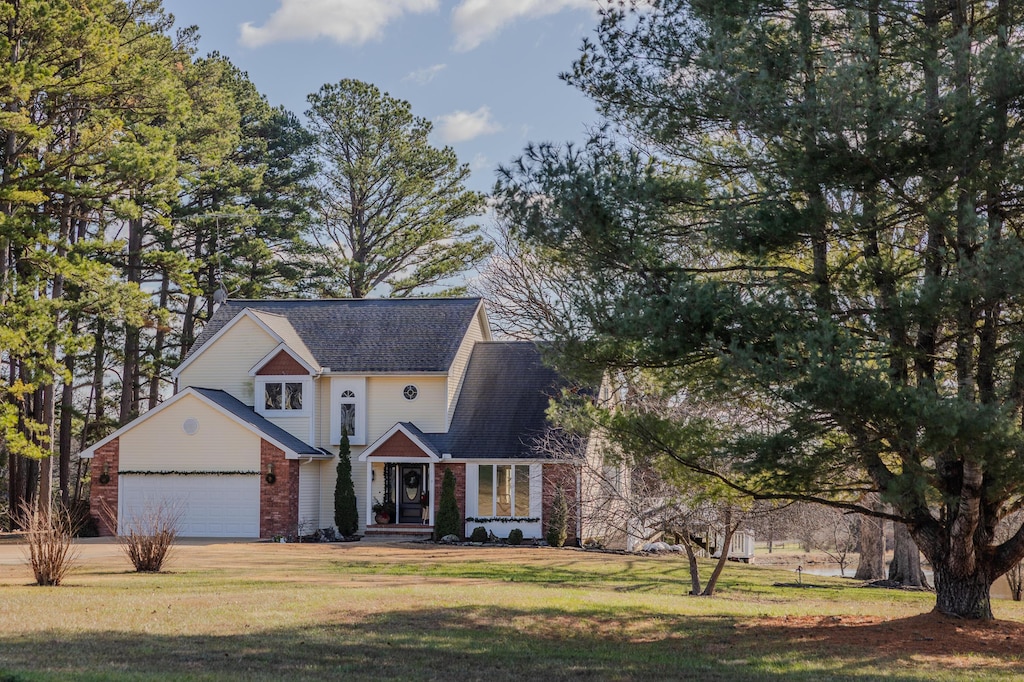 view of front of house with a garage and a front lawn