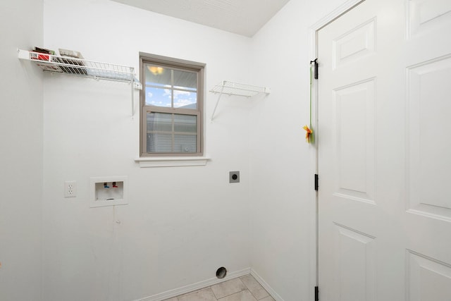 washroom featuring hookup for an electric dryer, light tile patterned floors, and washer hookup