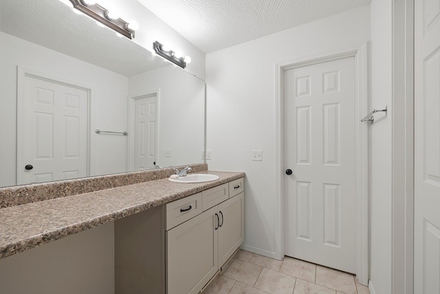 bathroom featuring tile patterned floors, vanity, and a textured ceiling