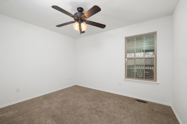 unfurnished room featuring ceiling fan and carpet floors