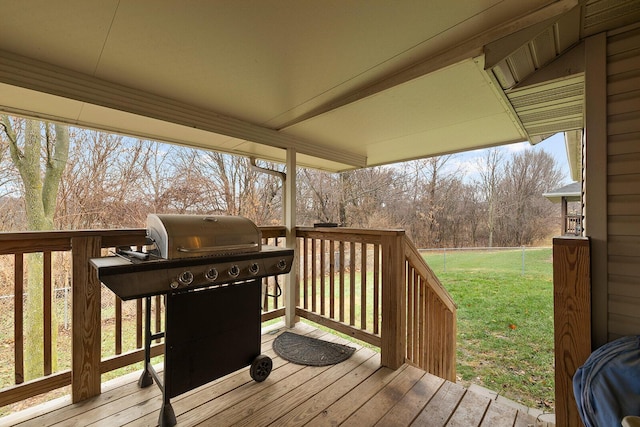 deck with area for grilling and a yard