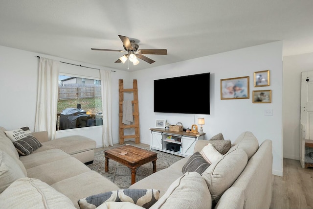 living room featuring light hardwood / wood-style floors and ceiling fan