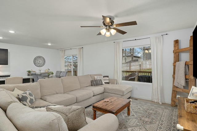 living room with ceiling fan, a healthy amount of sunlight, and light hardwood / wood-style floors