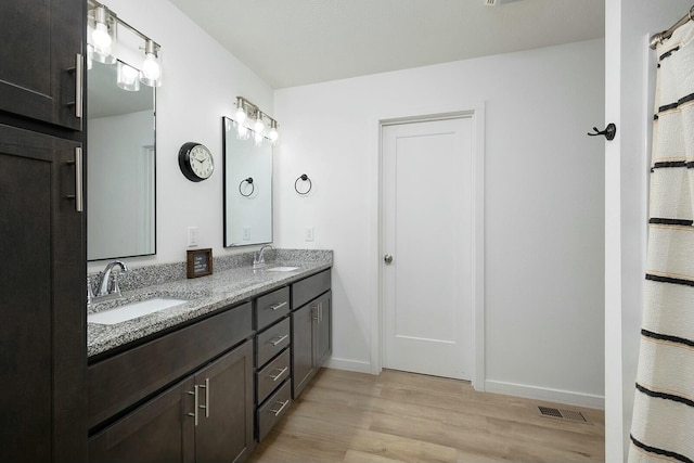 bathroom featuring hardwood / wood-style floors and vanity