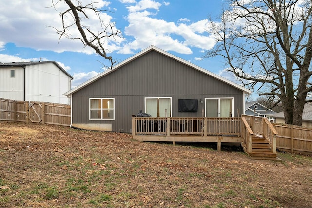 back of house featuring a wooden deck