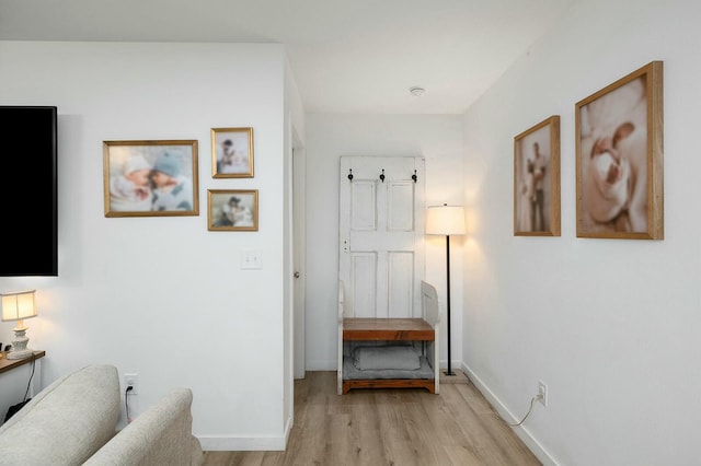 hallway with light hardwood / wood-style floors