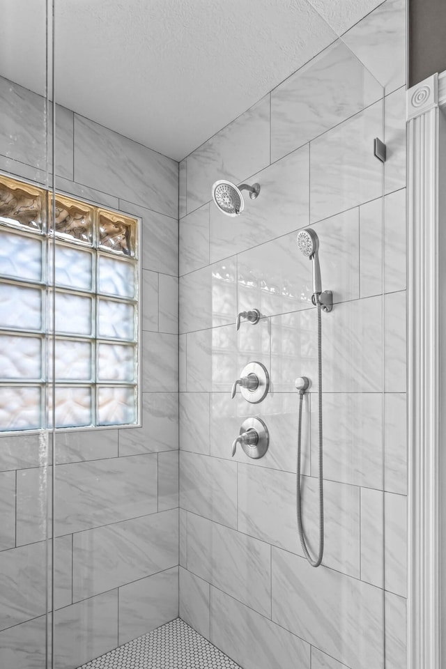 bathroom with a tile shower