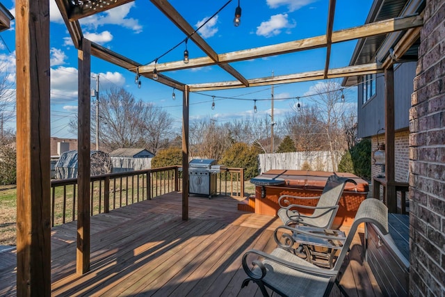 wooden terrace featuring a hot tub and grilling area