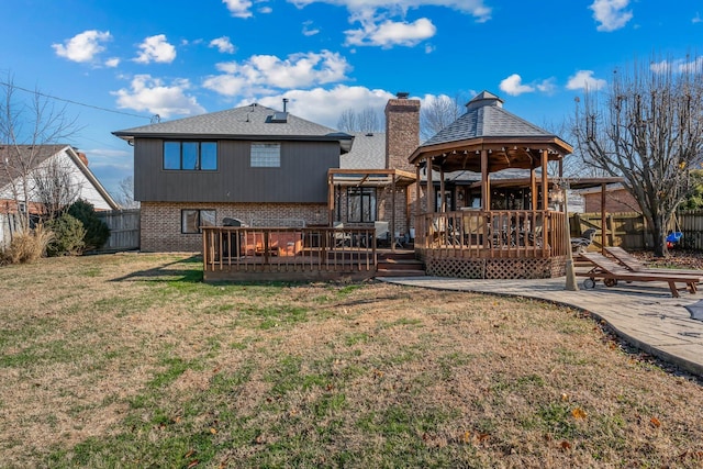 back of house featuring a gazebo, a yard, a deck, and a patio area