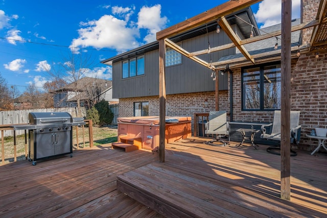 wooden deck featuring area for grilling and a hot tub