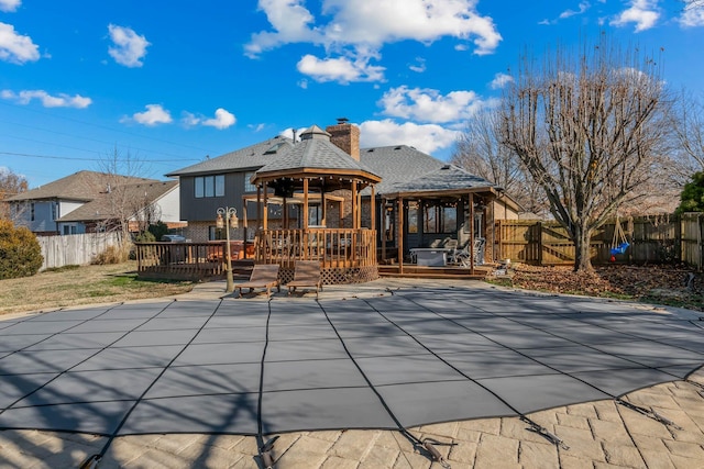 view of swimming pool with a patio, a sunroom, and a wooden deck