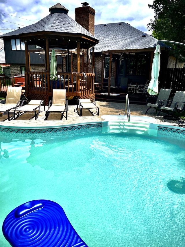 view of swimming pool featuring a gazebo and a patio