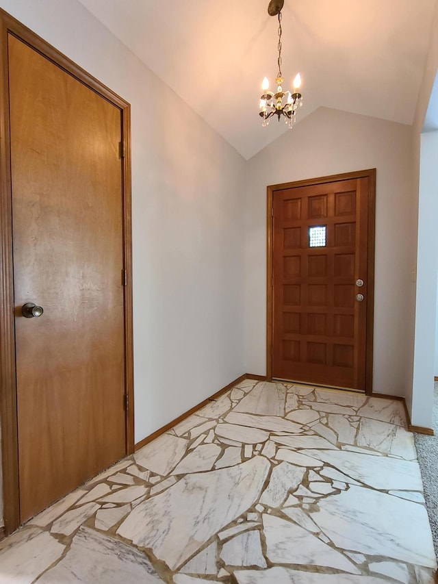 foyer with lofted ceiling and a notable chandelier