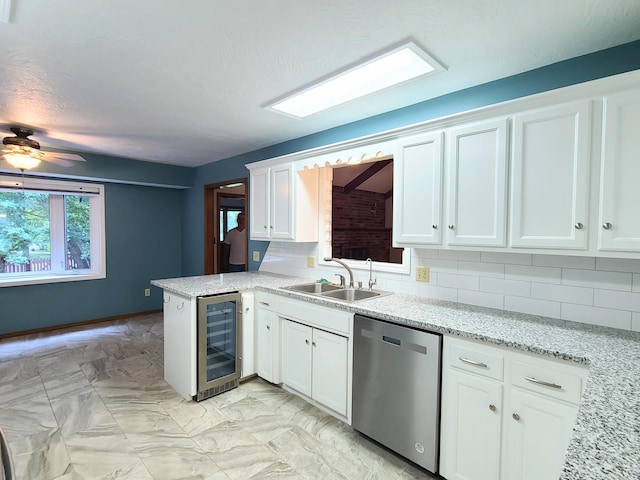 kitchen featuring dishwasher, white cabinets, wine cooler, backsplash, and kitchen peninsula