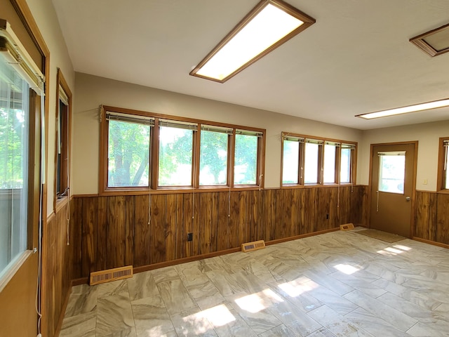 spare room with wood walls