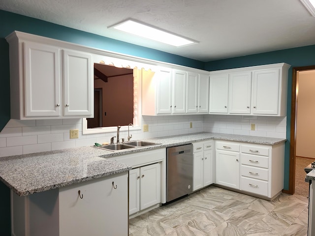 kitchen with white cabinets, decorative backsplash, sink, and dishwasher