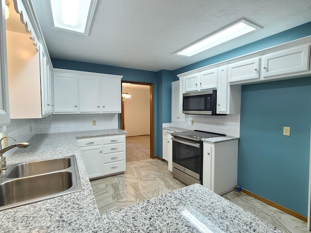 kitchen featuring white cabinets, sink, decorative backsplash, and electric range