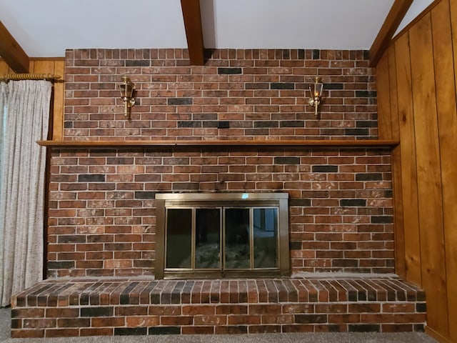 details featuring beamed ceiling, carpet flooring, and wooden walls