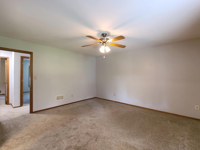 empty room with light colored carpet and ceiling fan