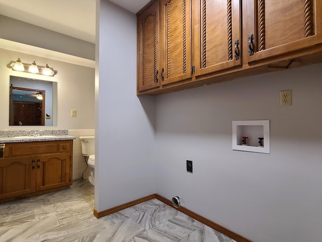 laundry area with electric dryer hookup, washer hookup, sink, and cabinets