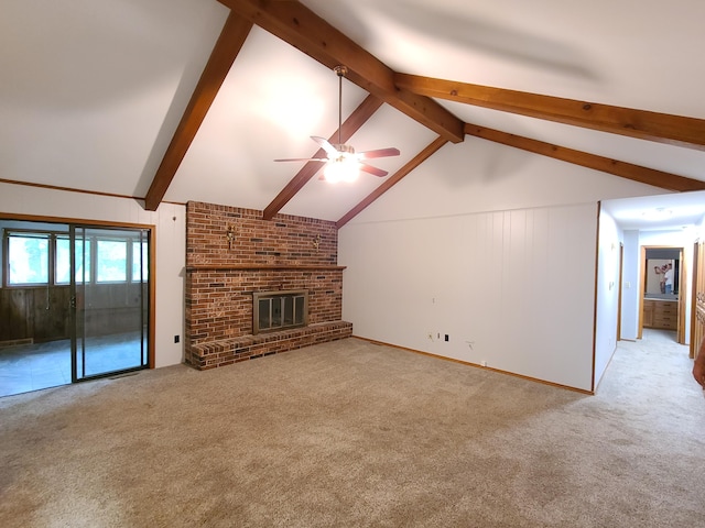 unfurnished living room featuring ceiling fan, light carpet, a brick fireplace, and vaulted ceiling with beams