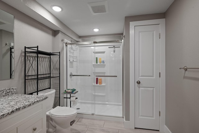 bathroom with vanity, toilet, and walk in shower