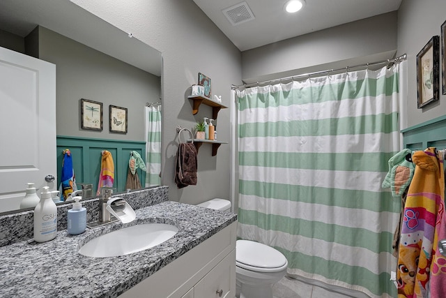 bathroom with vanity, toilet, and walk in shower