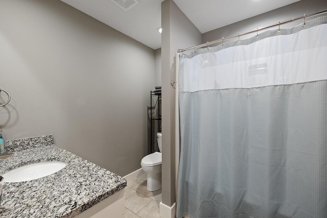 bathroom featuring tile patterned floors, vanity, and toilet