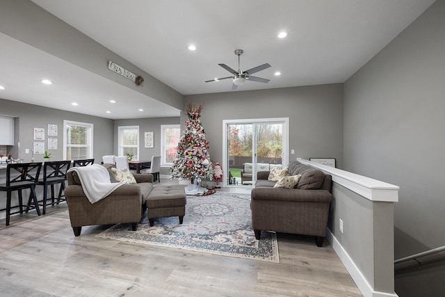 living room with ceiling fan and light wood-type flooring