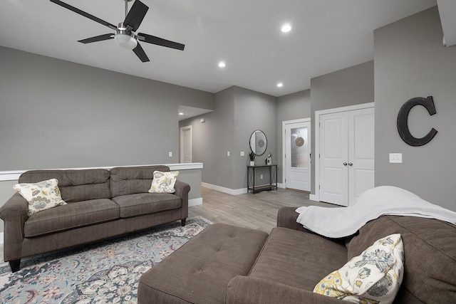 living room featuring ceiling fan and light wood-type flooring