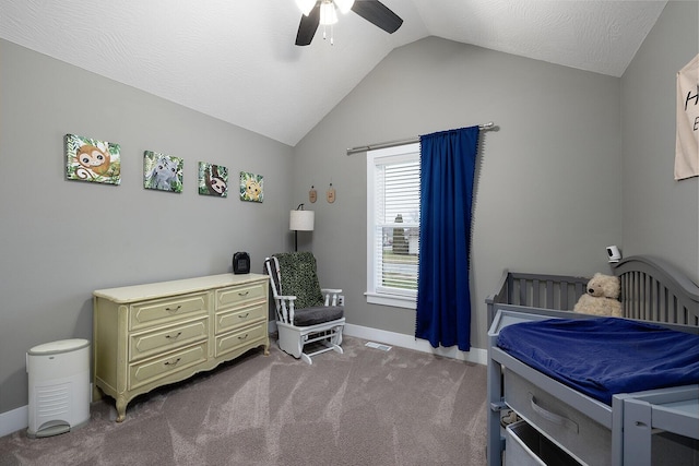 bedroom featuring a textured ceiling, ceiling fan, carpet, and vaulted ceiling