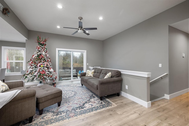 living room with a wealth of natural light, ceiling fan, and light hardwood / wood-style floors