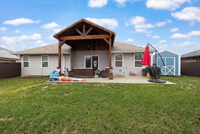 back of property featuring outdoor lounge area, a storage unit, a yard, and a patio