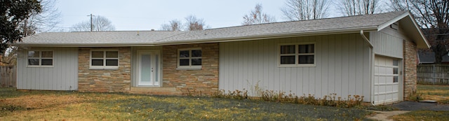 rear view of property featuring a lawn