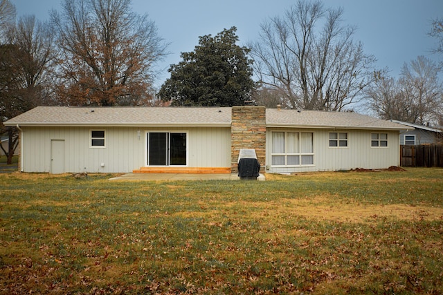 rear view of house with a yard