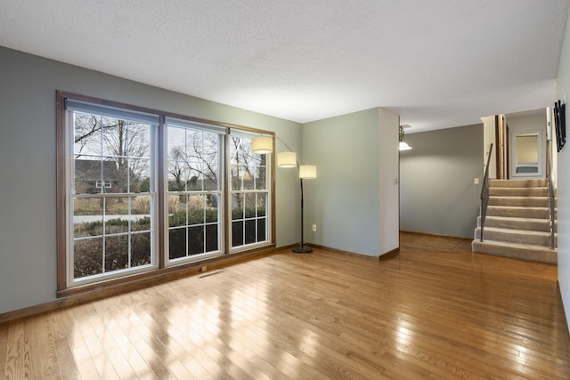 interior space with a textured ceiling and light wood-type flooring